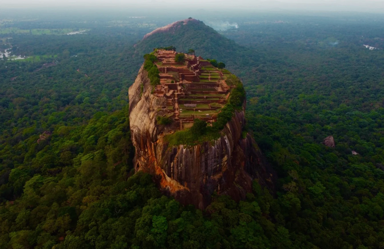 Imagen de una zona de selva en Sri Lanka en la que aparece en el centro una montaña con una zona poblada en su cima plana